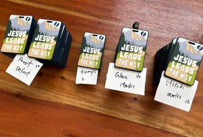 Praise the Lord tags Out of 100 pieces 62 have visible defects or issuesJesus Lead the Way tags Out of 100 pieces 70 have visible defects or issuesAround these major issue  Paint defects Bumps or air bubbles Glue marks Stitch marksI already email imprint for further assistant