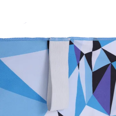 A close-up of a custom printed towel with a geometric blue and purple pattern, featuring a white hanging loop on the top edge.