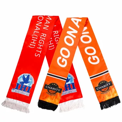Custom rally towels in red and orange featuring printed text and logos, advertising a charitable cause, displayed against a white background.