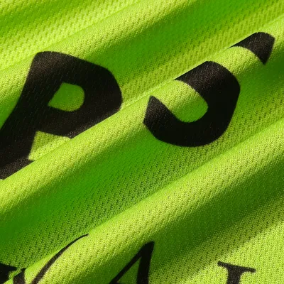 Close-up of a lime green custom printed towel with bold black lettering, highlighting the texture and detail of the personalized design.