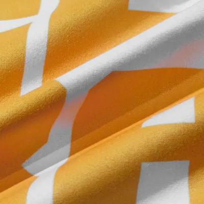 Close-up of a custom printed towel with a white and orange design, highlighting the texture and quality of the fabric.